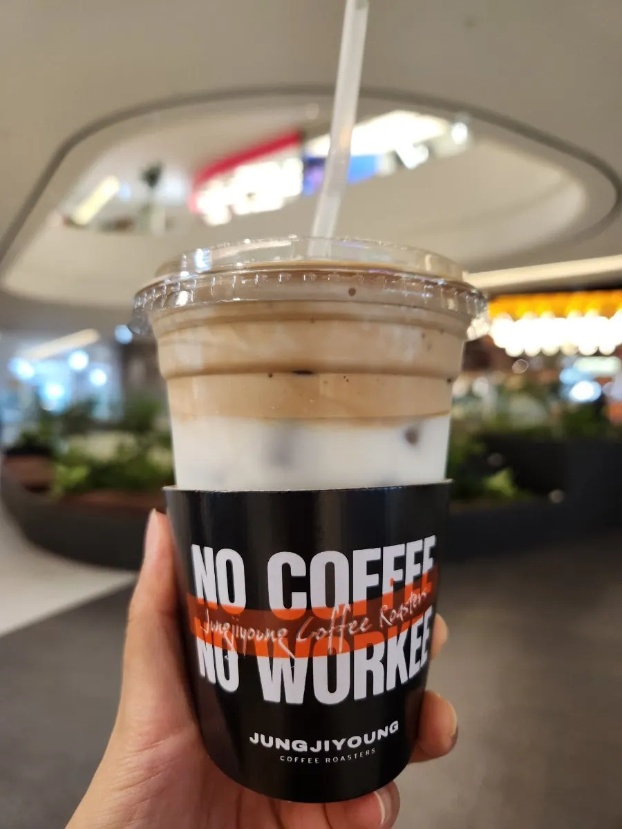 A cup of coconut coffee topped with coconut cream