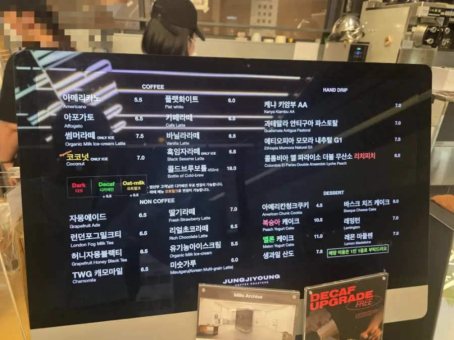Order counter with the Jeong Jiyeong Coffee Roasters menu board