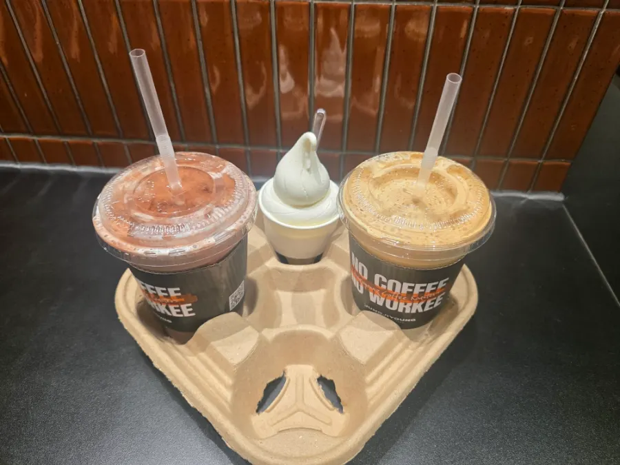 Two takeout cups of coconut coffee and choco latte