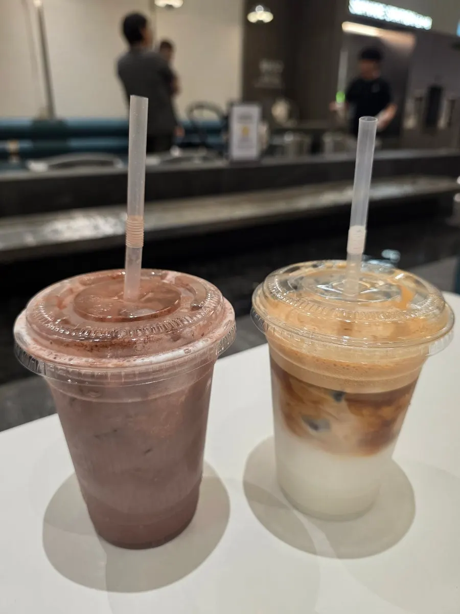 Choco latte and coconut coffee on a food court table