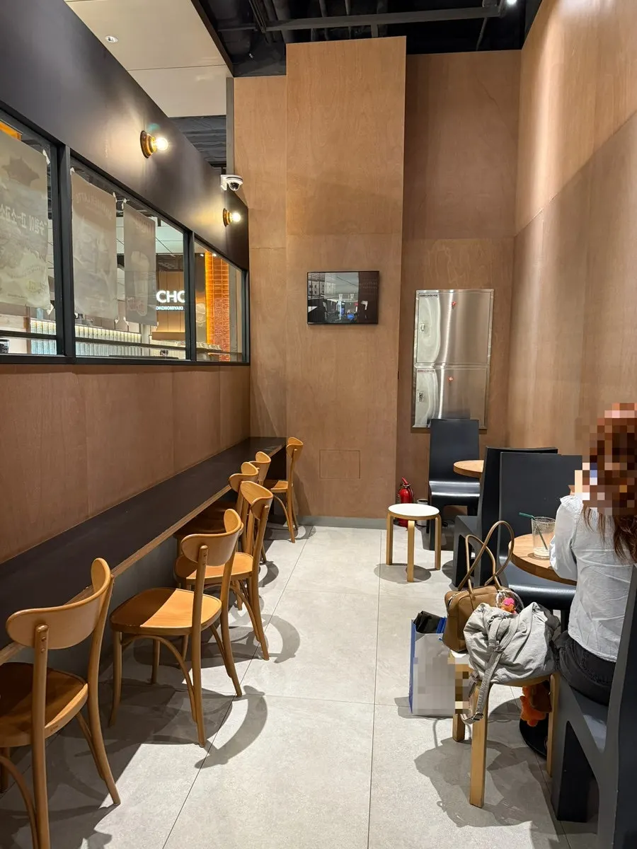 Café interior with wide table spacing and wood decor