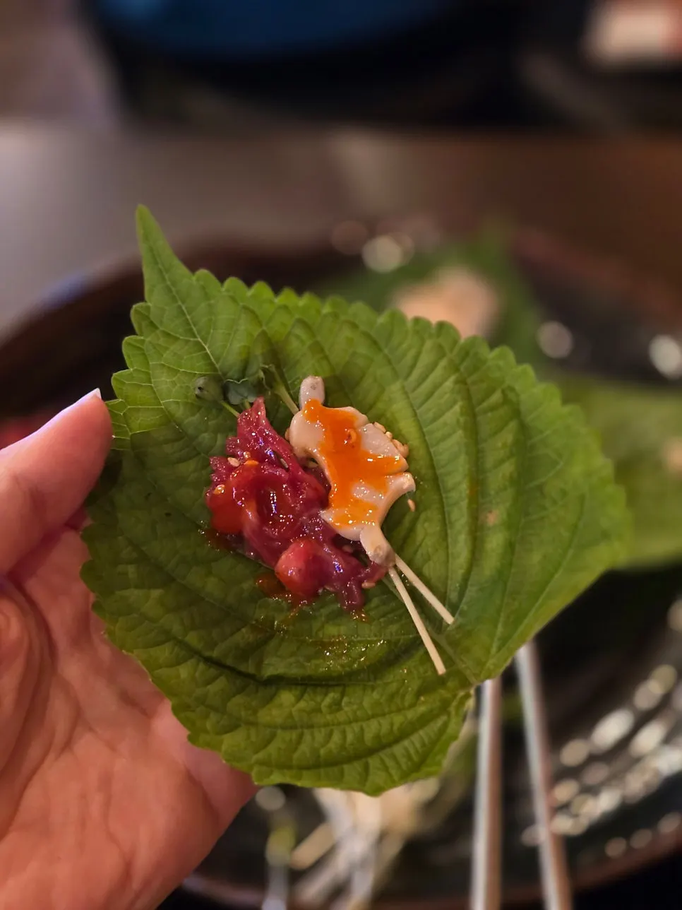 A piece of abalone placed on top of yukhoe