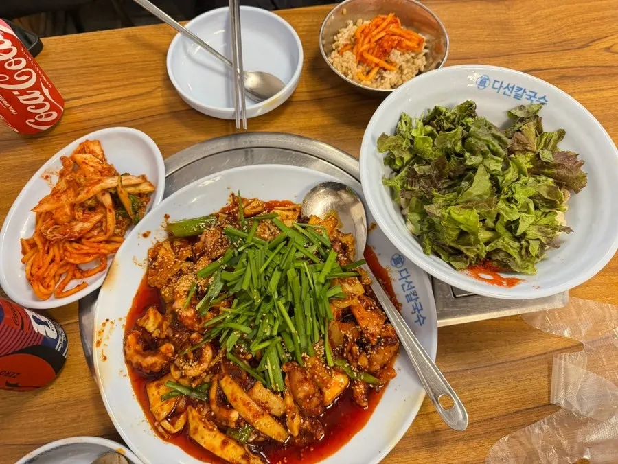 Full spread of dishes served to two people at Daseon Kalguksu