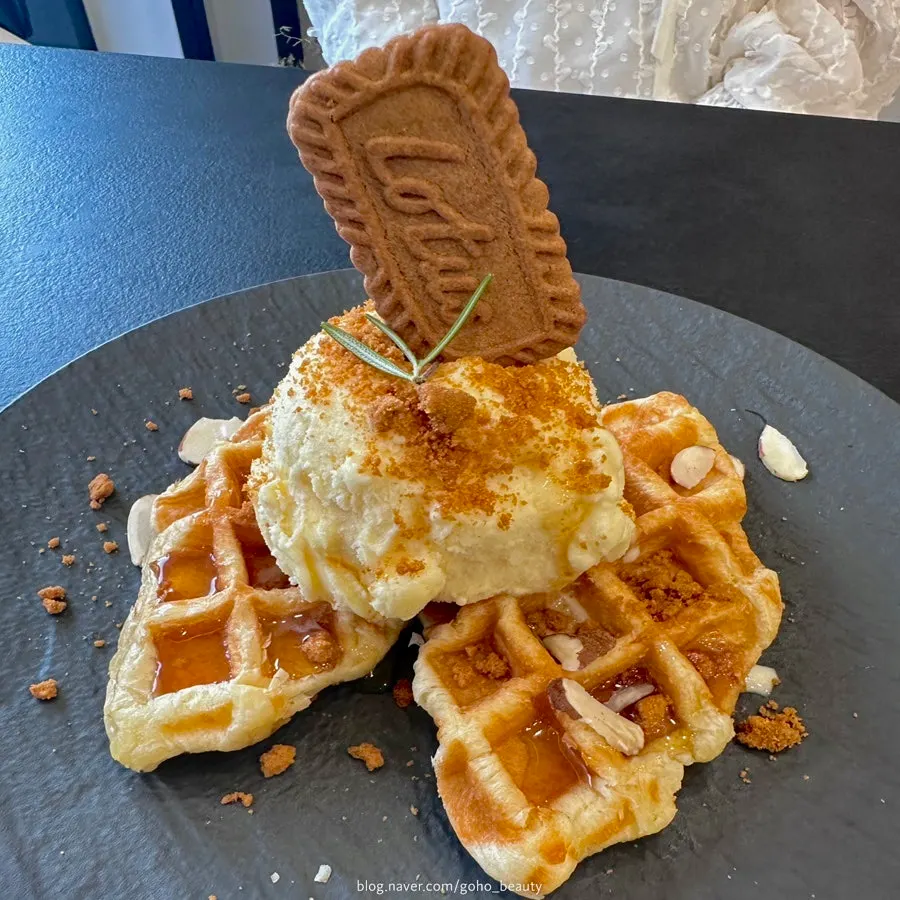 Generous scoop of Lotus ice cream on top of two croffle slices
