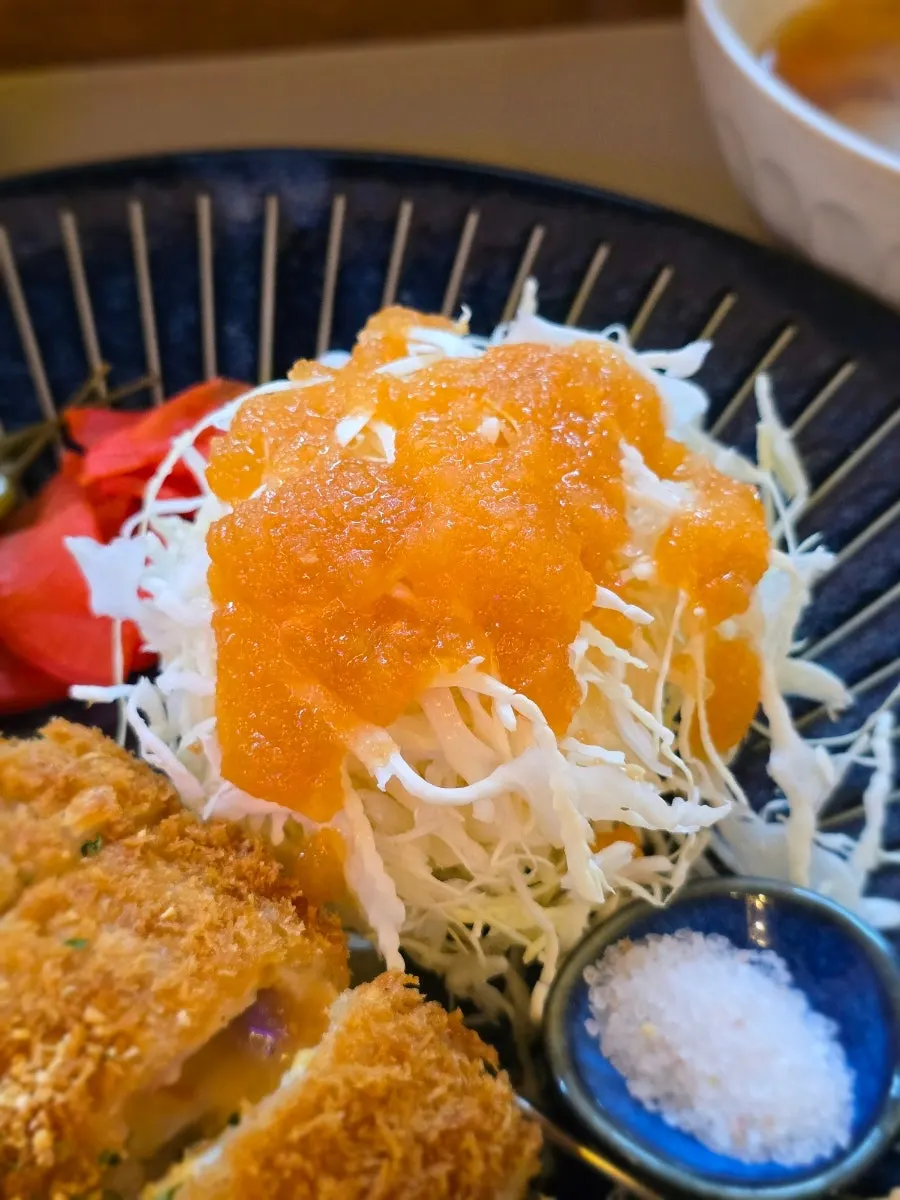 Cabbage salad topped with apple-and-carrot dressing