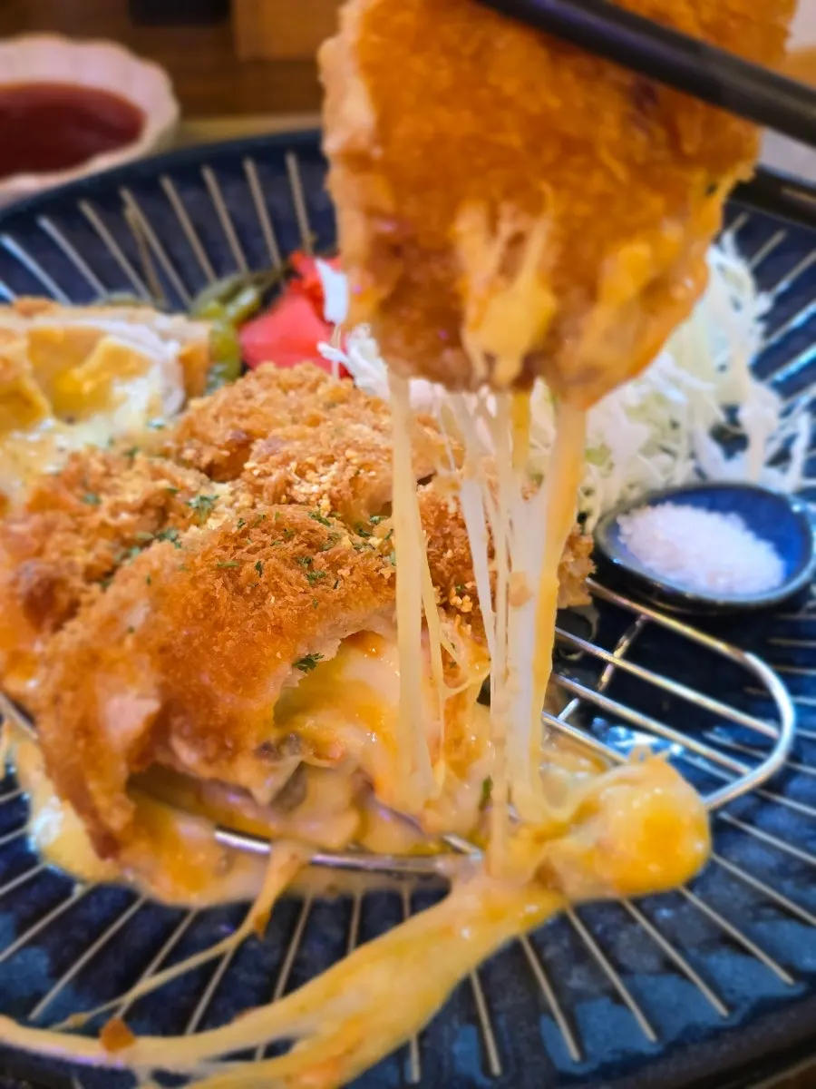 Cross-section of the cordon bleu pork cutlet showing its crispy coating