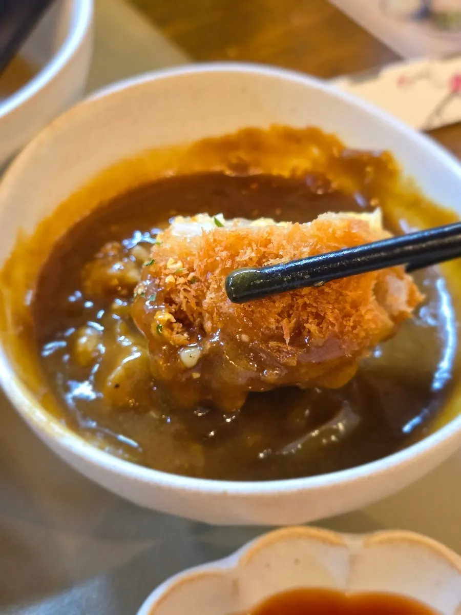Pork cutlet dipped into the mini curry
