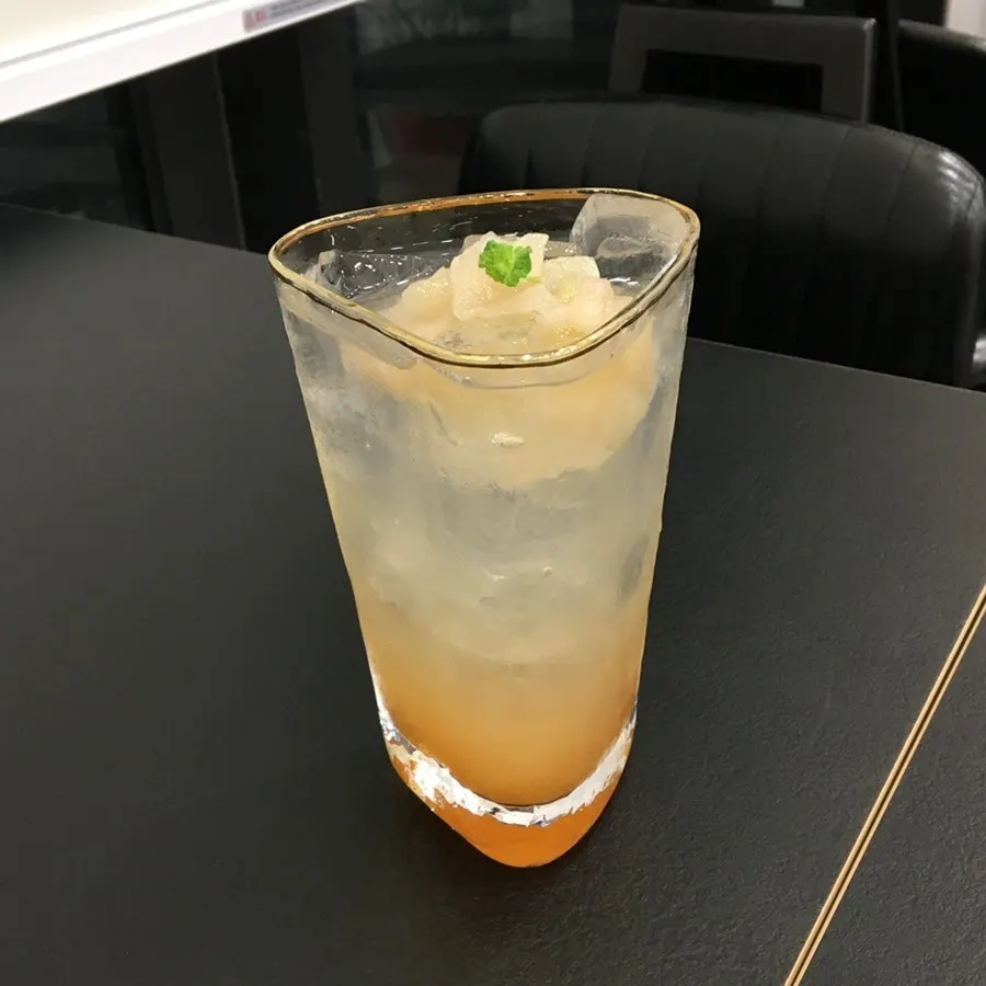 Glass of peach tea ordered alongside