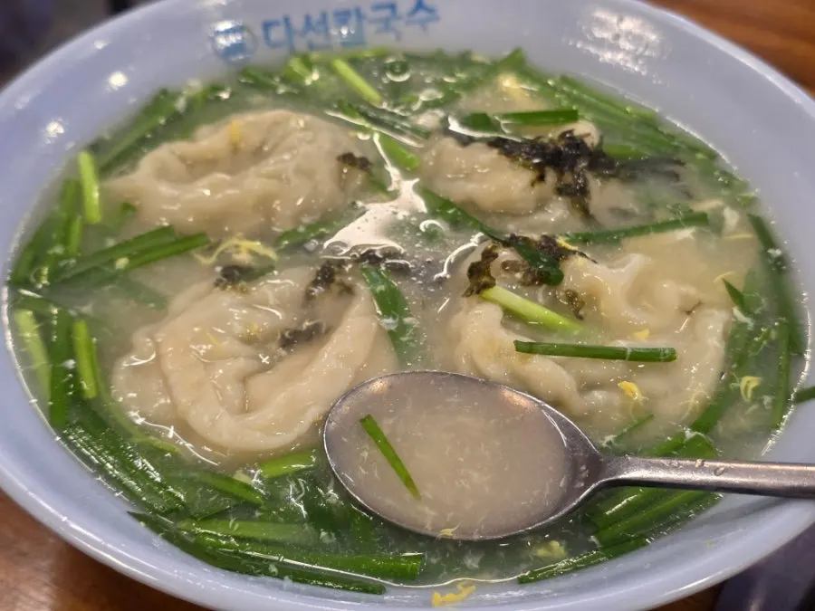 A spoonful of mandu-guk broth with whisked egg