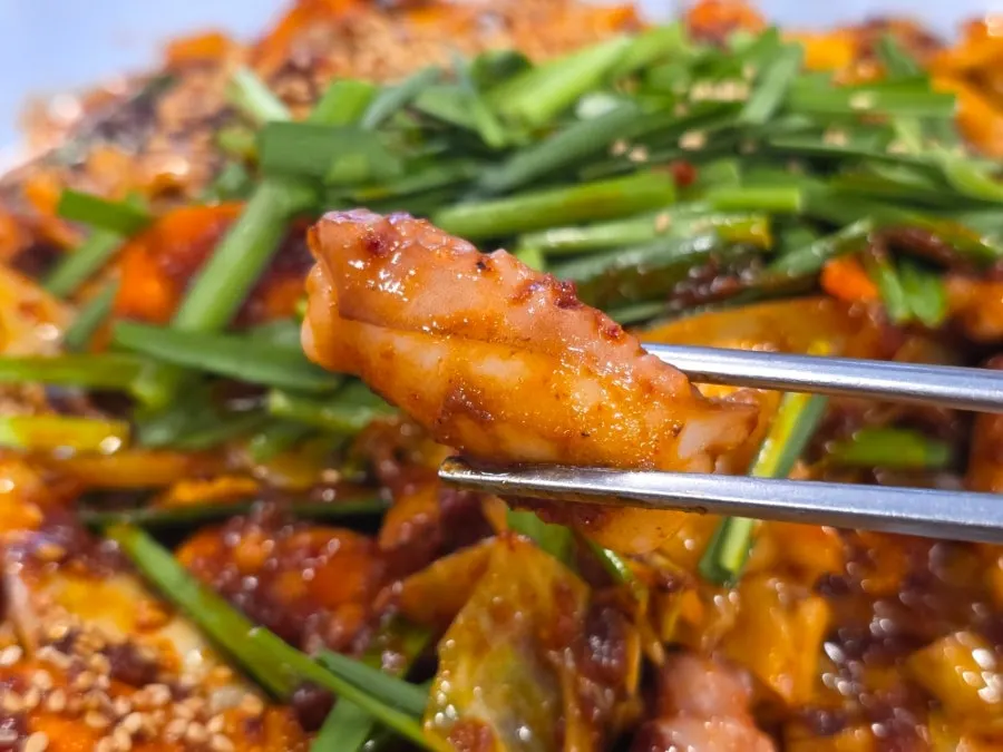 Close-up of big, plump octopus pieces in the stir-fry