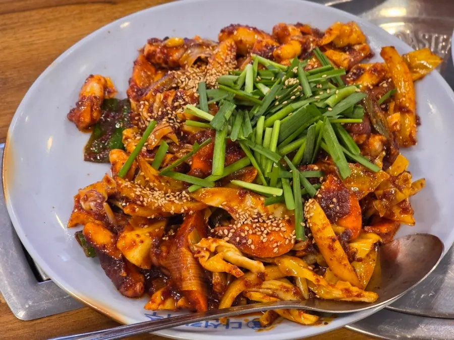 Full table setup with mandu-guk and stir-fried octopus
