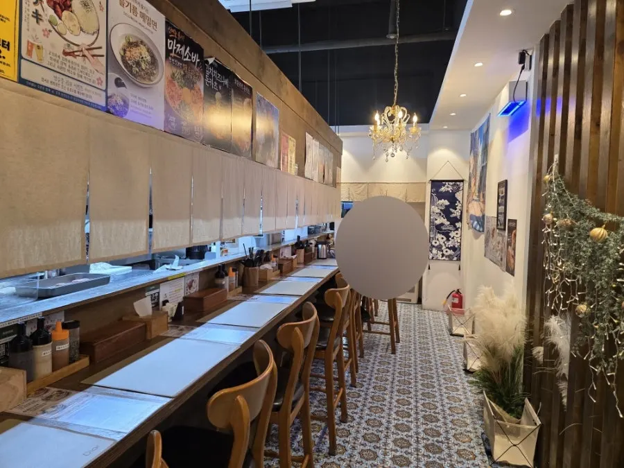 Counter tables and open kitchen inside Gohobi Katsu
