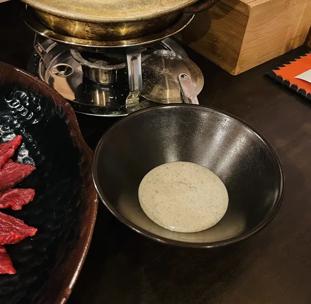 A bite of yukhoe mixed with egg yolk
