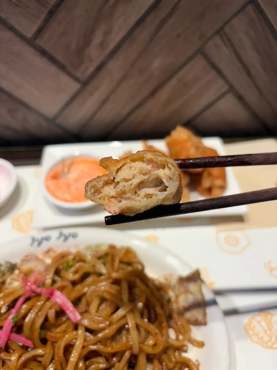 Cross-section of a gyoza dipped in mentai sauce
