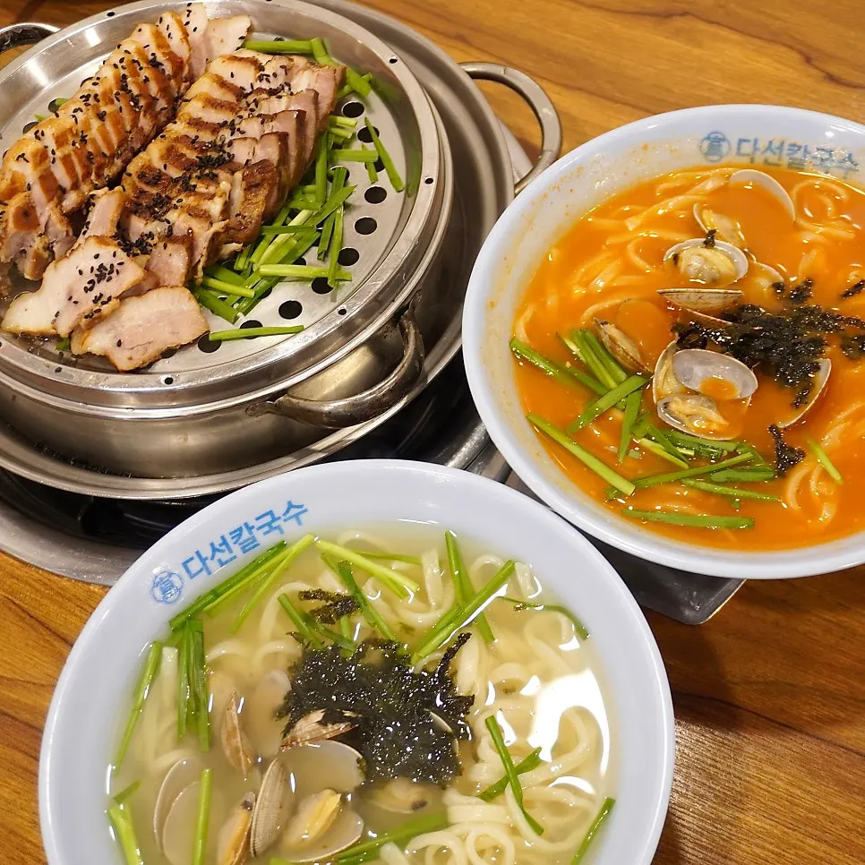 A spoonful of jang-kalguksu broth and noodles