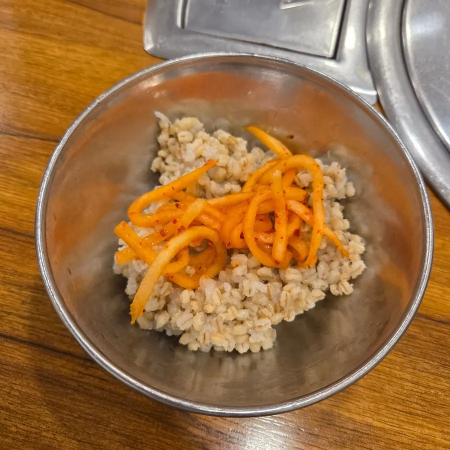 Barley rice, fresh kimchi and radish salad served as standard sides