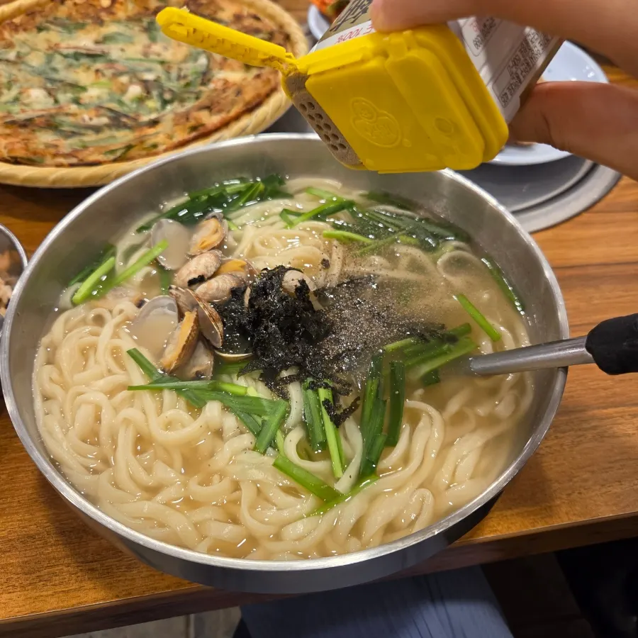 Kalguksu broth with pepper sprinkled on top