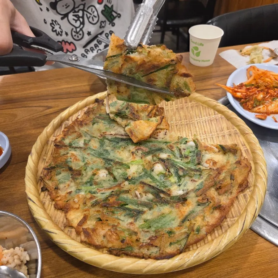 A piece of seafood pajeon with seafood mixed in
