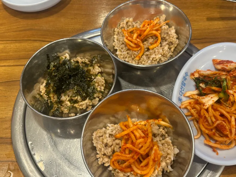 Radish salad and fresh kimchi side dishes at Daseon Kalguksu