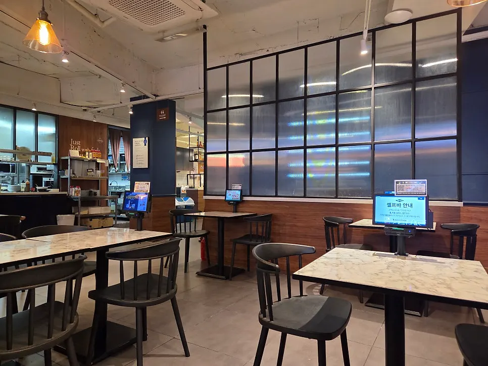 Dining hall with widely spaced tables at Rolling Pasta Suwon Station Branch