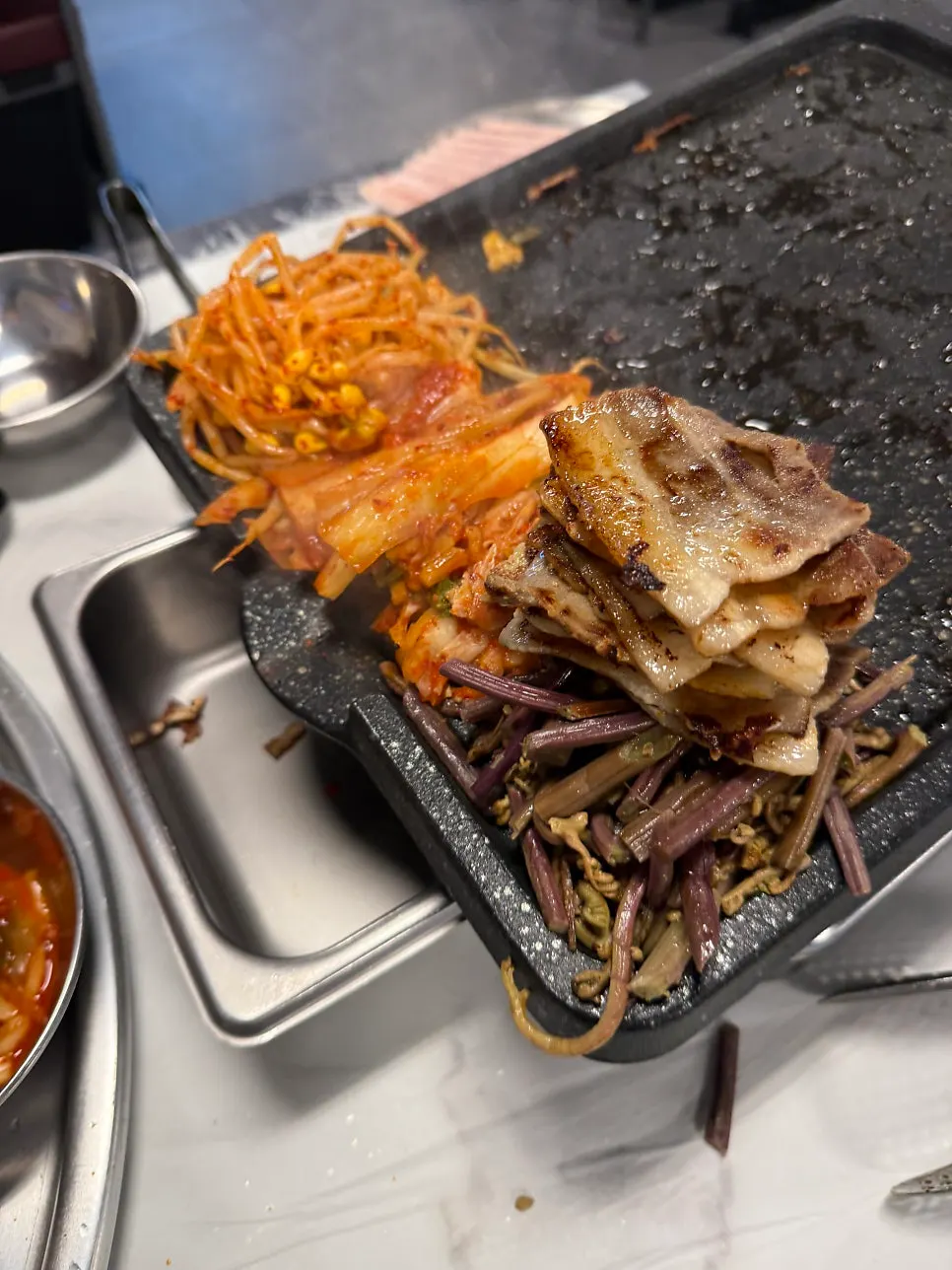 Kimchi, bean sprouts and bracken fern grilled together with the meat