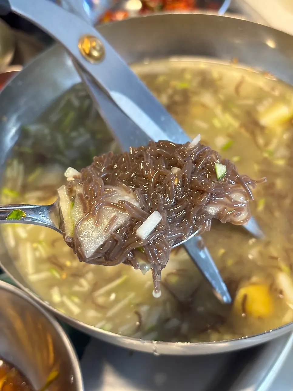 Mul-naengmyeon noodles cut small with scissors