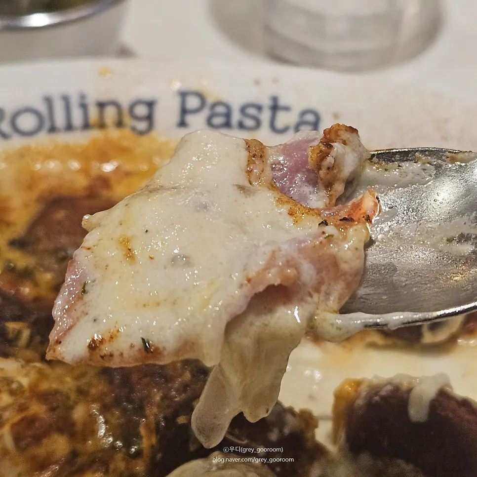 A spoonful of potato gnocchi with mushroom and bacon
