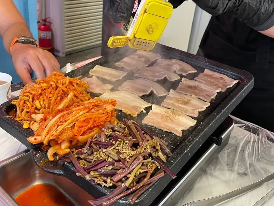 Grill at Taejang Sikdang cooking frozen pork belly