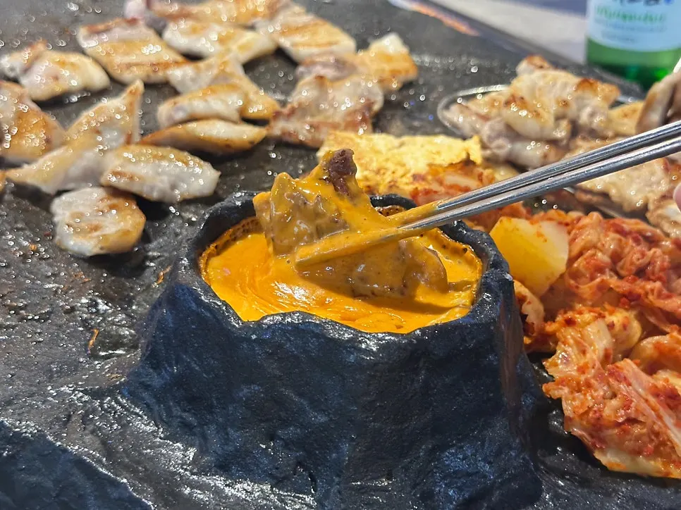 A piece of meat coated in plenty of cheese sauce