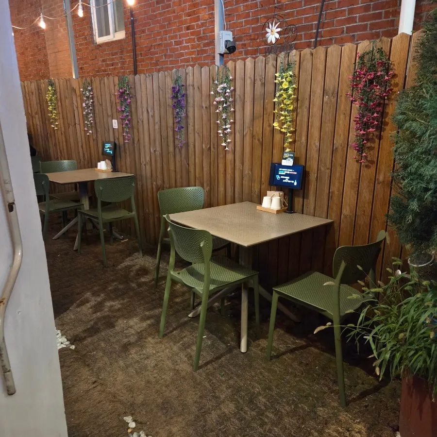 Outdoor tables with wood fencing and flower decorations