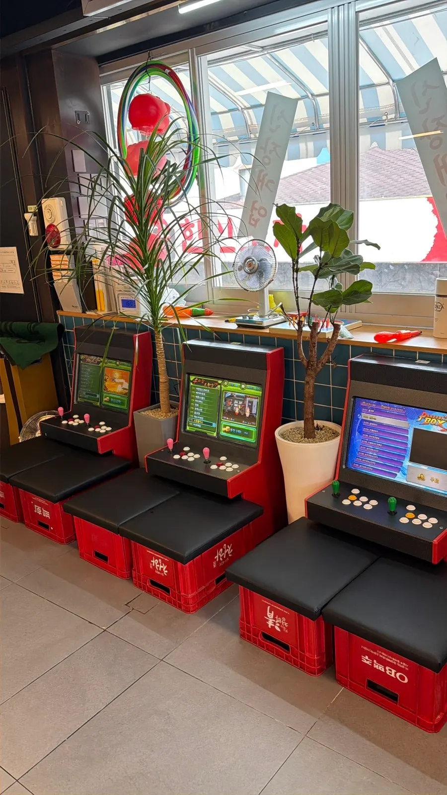 Mini arcade machine corner with beer crate seating