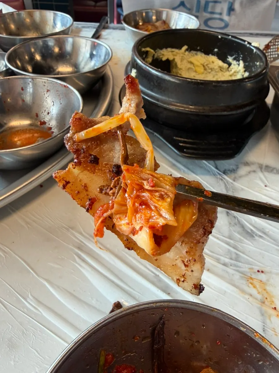 Extra fresh pork belly piled onto the grill