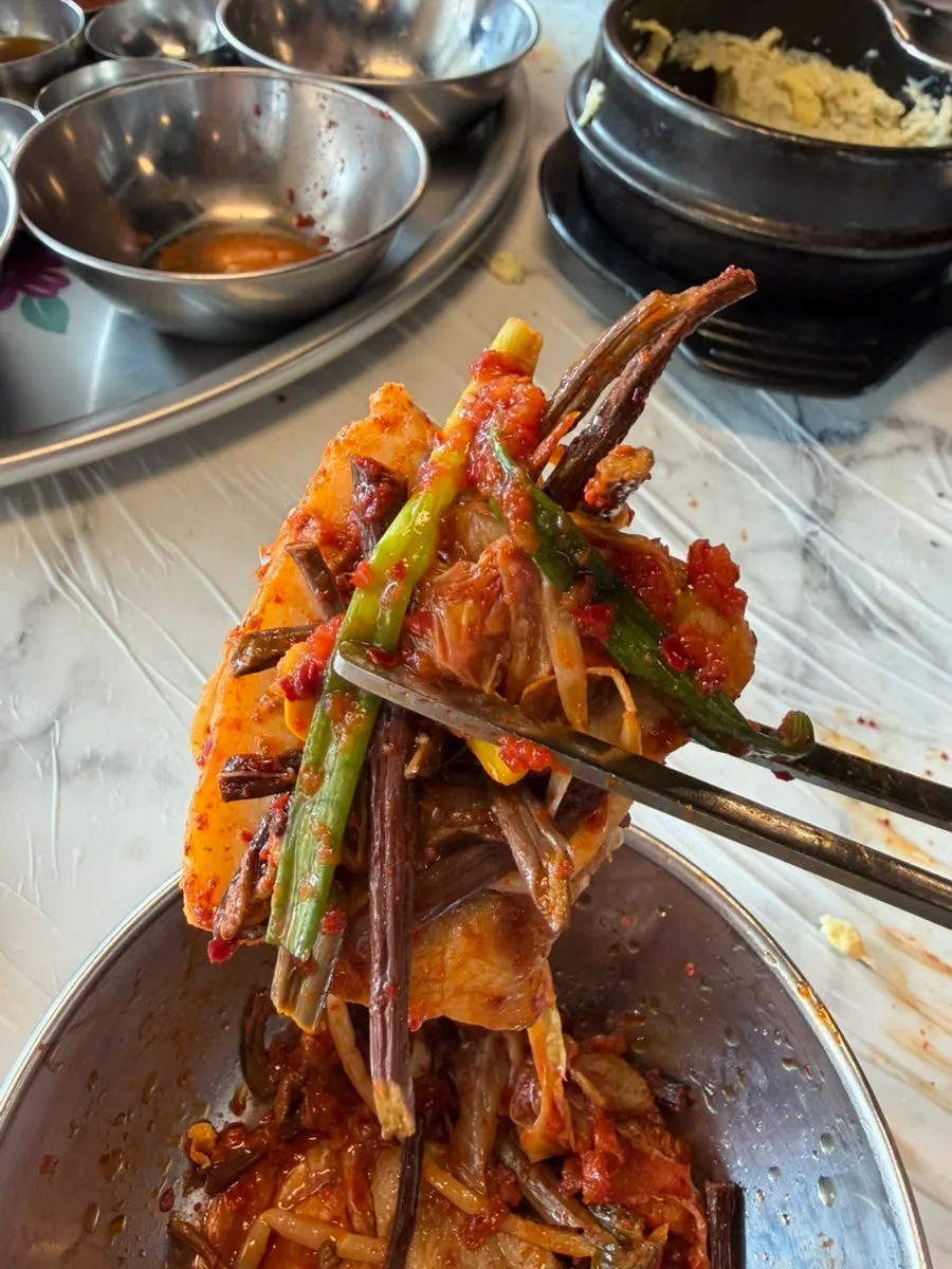 A piece of pork belly topped with sliced scallions