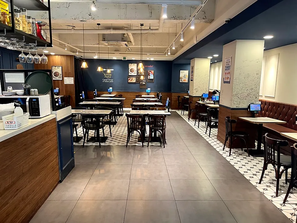 Seating area lined with 2-person tables