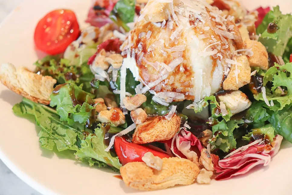 Salad with croutons, walnuts, and cherry tomatoes