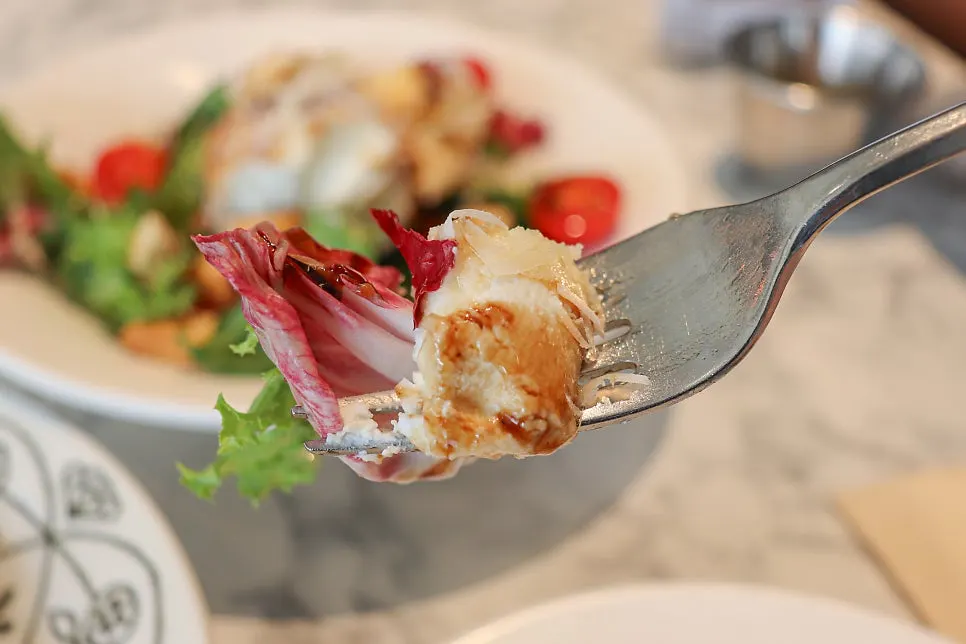 A piece of ricotta cheese with balsamic dressing
