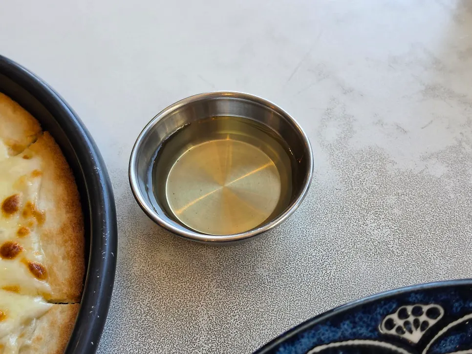 A slice of gorgonzola pizza drizzled with honey