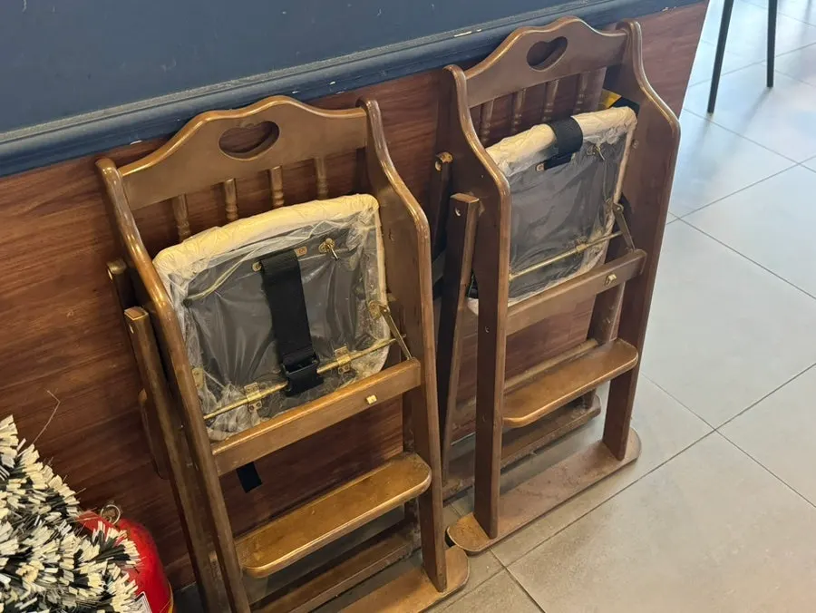 Aprons hanging on the wall and a baby chair
