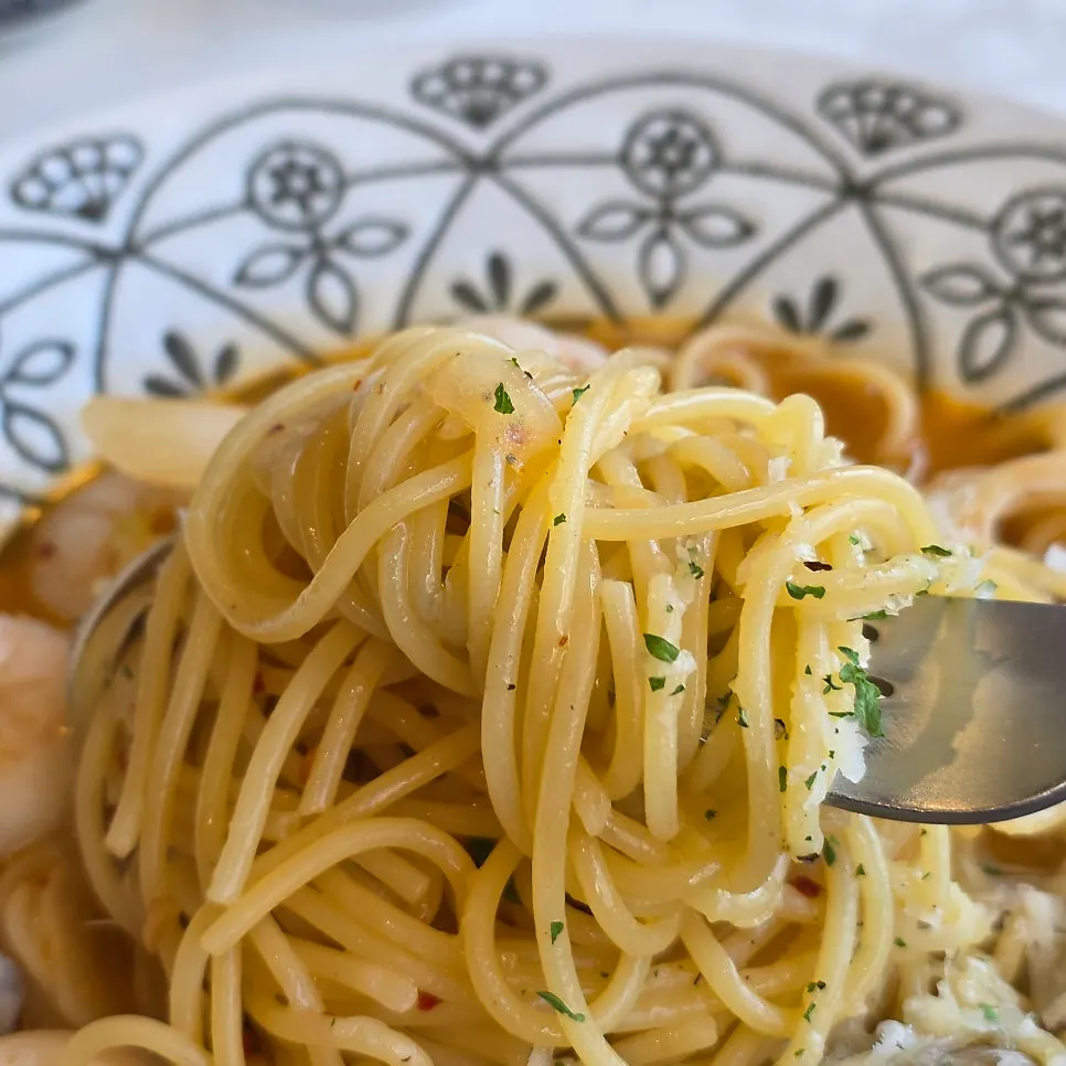 Cream pasta topped with snowy cheese and sausage