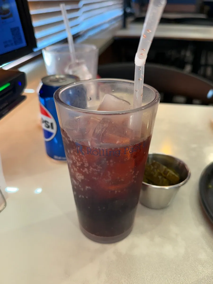 A glass of cherry coke included in the set