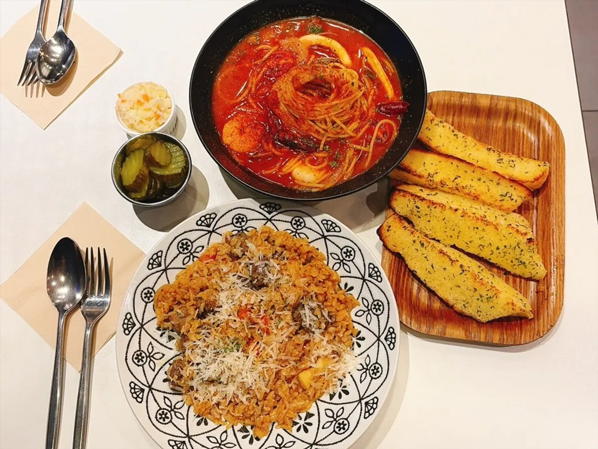 Table spread of steak pilaf and pache pasta