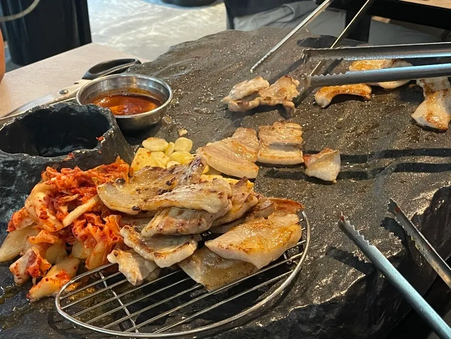 Staff grilling the pork belly