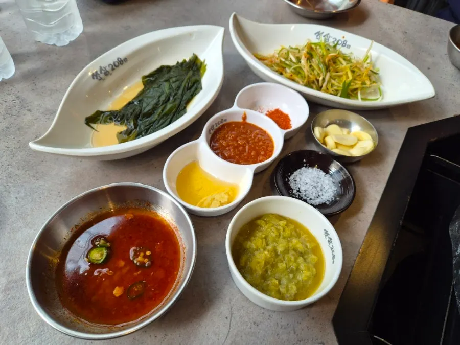파채무침과 명이나물, 소스가 놓인 기본찬 상차림