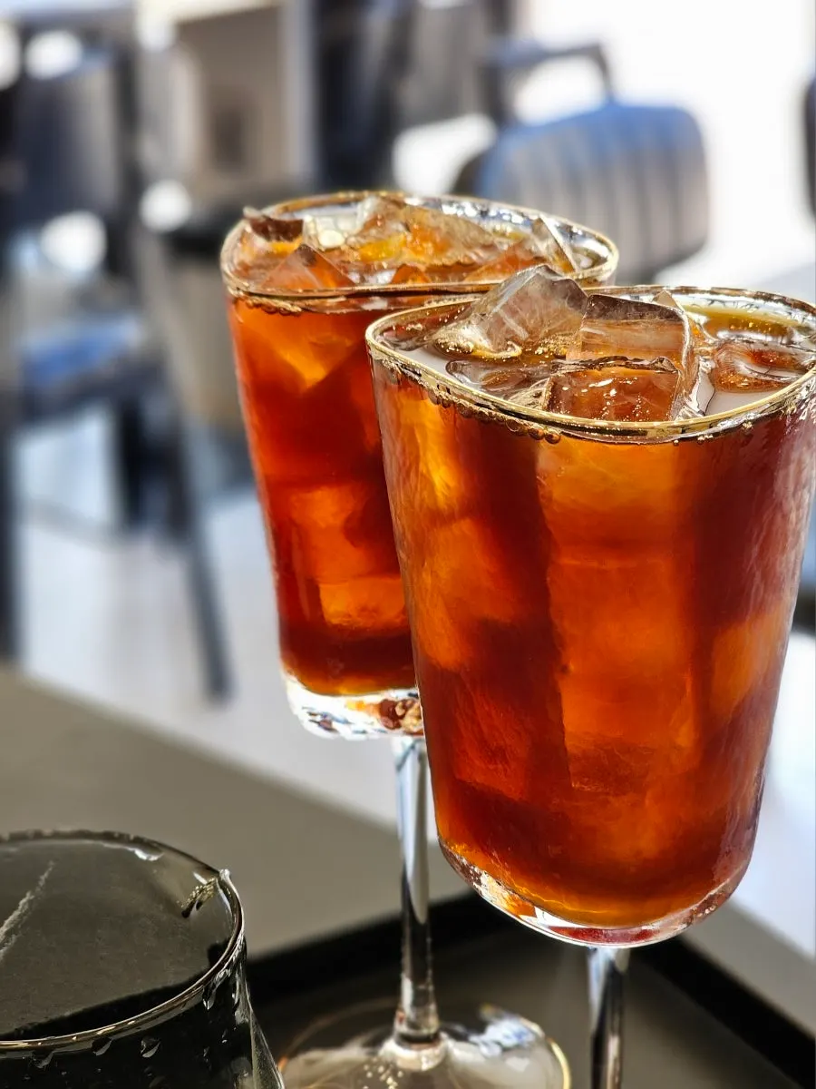 Iced Americano poured into a wine glass