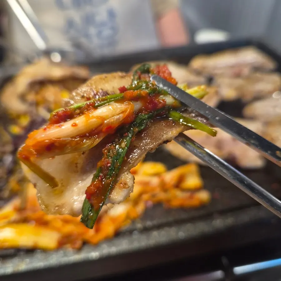 Scallion kimchi served as a side dish with frozen pork belly