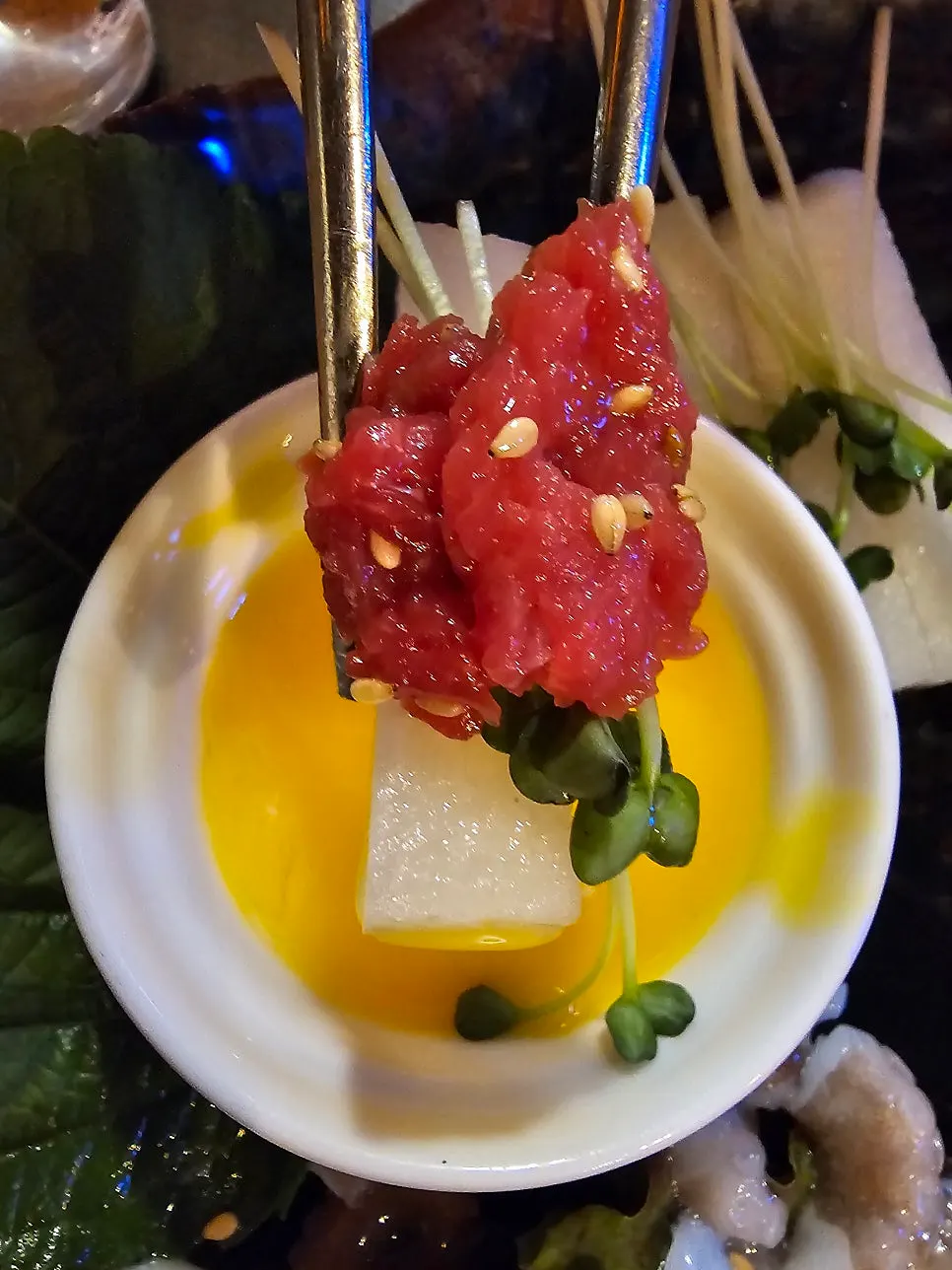 A piece of yukhoe served with pear and radish sprouts