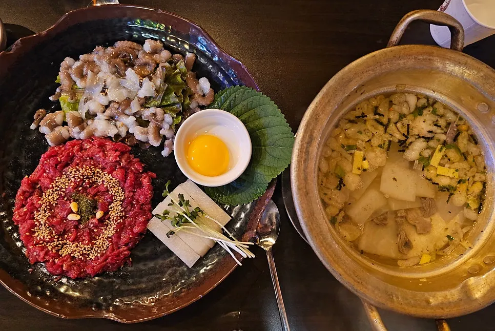 A full spread of live octopus hanwoo yukhoe ready to eat