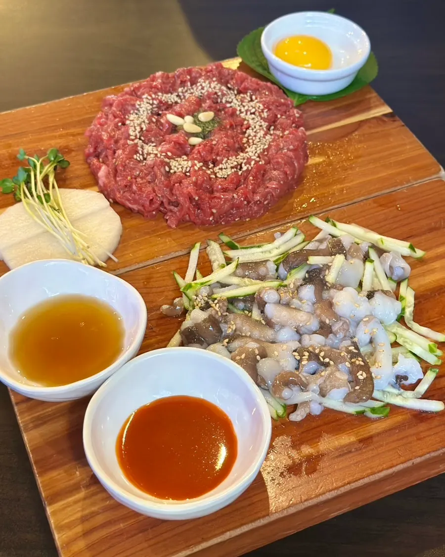Table set with hanwoo yukhoe and live octopus together