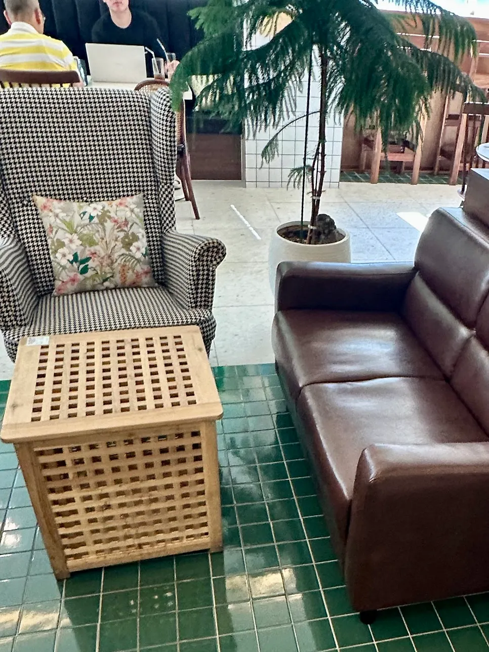 Open café seating by floor-to-ceiling windows