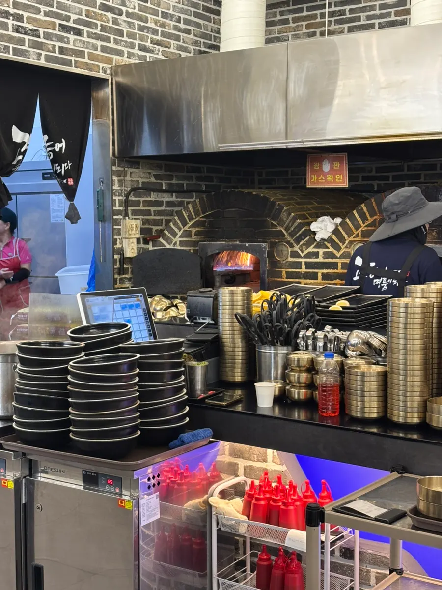 Wood-fired oven visible inside the restaurant
